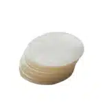 Fanned stack of round cellophane patty discs on a white background